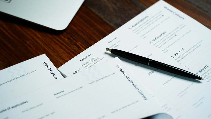 Illustration of medical documents, dictionaries, and multilingual icons on a clean desk